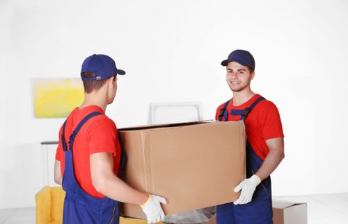 Loading furniture and boxes into a moving truck in Morden