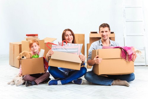Student removals team handling boxes outside a Morden flat