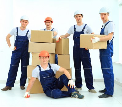 Office furniture and equipment being moved for a business relocation in Morden